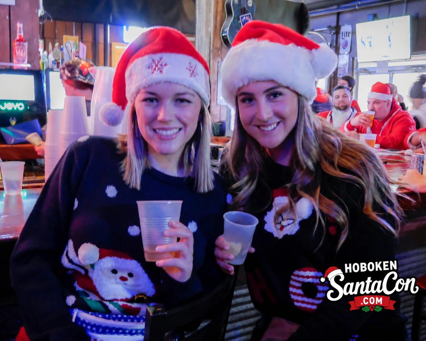 Ugly Christmas sweater girls at SantaCon bar