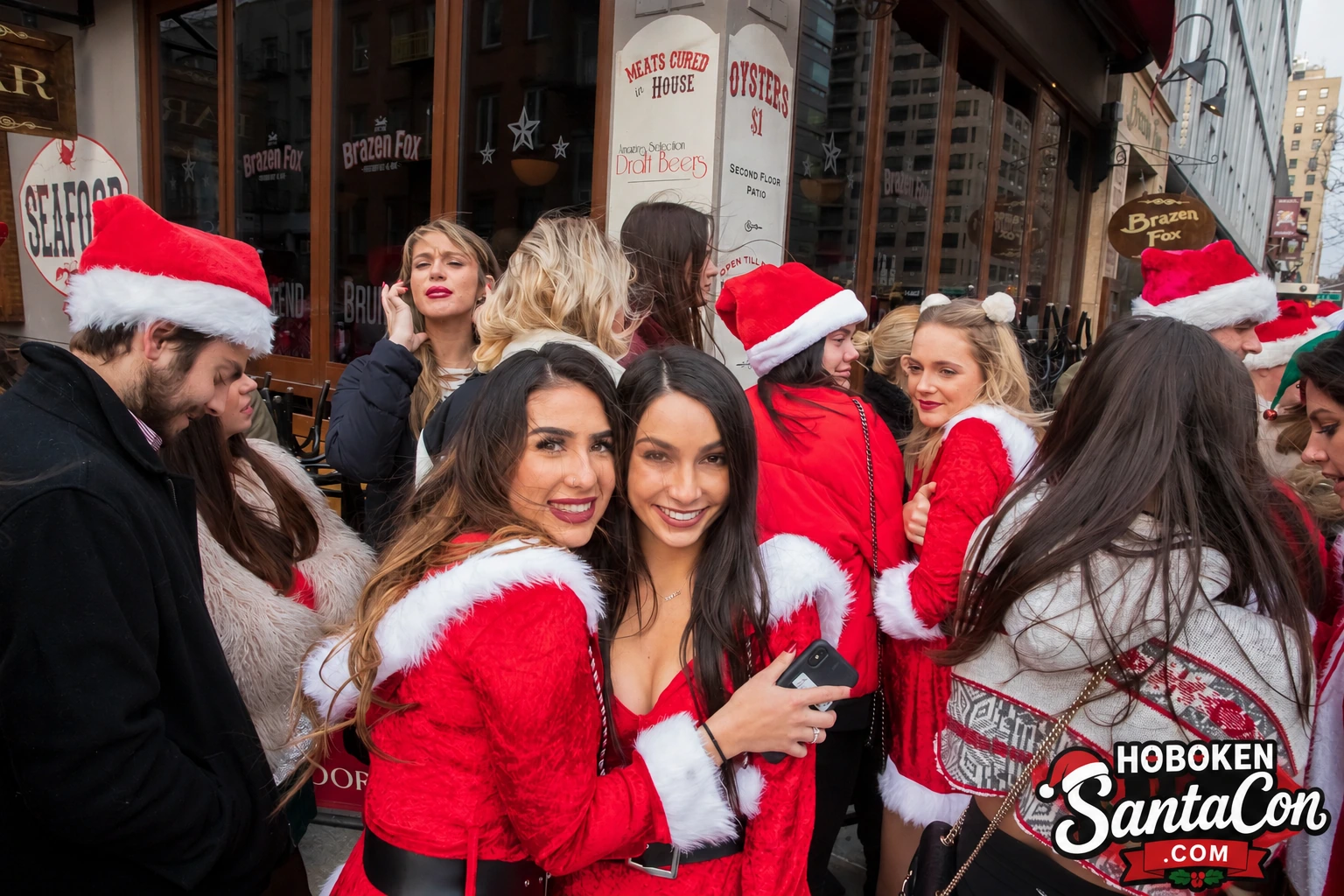 Hoboken SantaCon crowd celebrating outside a participating bar