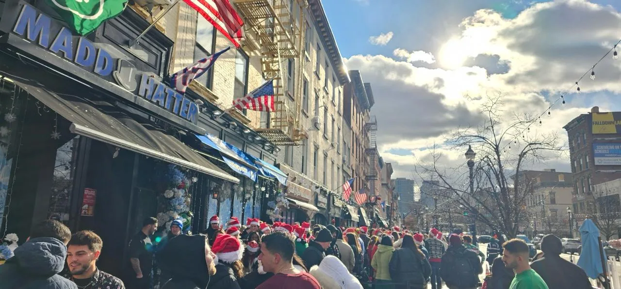 Thousands of Santas filling Washington Street outside Madd Hatter during Hoboken SantaCon